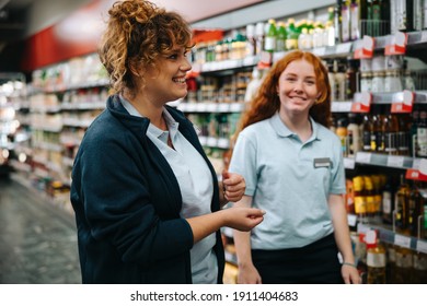 Trainer Teaching Customer Service Skills To A New Female Employee. Supermarket Manager Training Young Woman Worker.