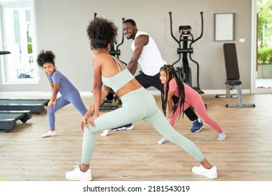 Trainer Woman Is Leading African American Family Workout Exercise In Sport Club , Healthy And Wellbeing Life Concept