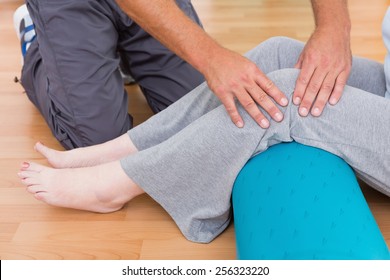 Trainer working with senior woman in fitness studio - Powered by Shutterstock