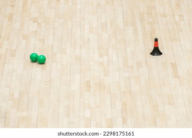 Training cones and ball on hardwood court floor. Basketball, futsal, handball and volleyball practice. Game equipment Horizontal sport theme poster, greeting cards, headers, website and app - Powered by Shutterstock