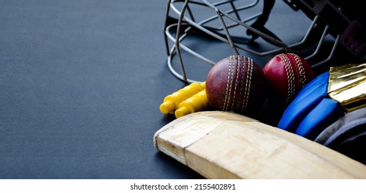 Training cricket sport equipments, bat, ball, gloves, wickets, and helmet, on dark floor, concept for cricket sport lovers all over the world. - Powered by Shutterstock