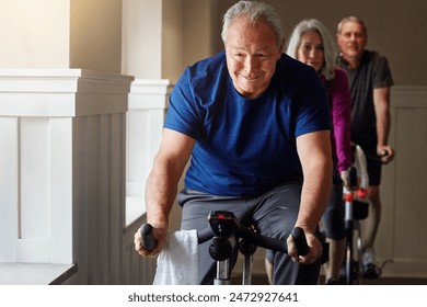 Training, cycling and senior man in gym for spinning class, exercise and fitness with physical activity. Workout club, people and team on bike machine for health, wellness and endurance with cardio - Powered by Shutterstock