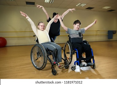 Training for dance competition of inclusive dance of handicapped children on wheelhairs with trainers in sport hall in Estonia, optimism and desire to act