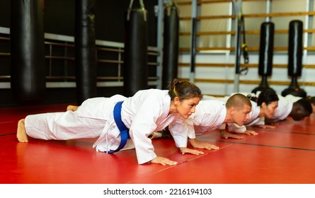 Training a group of athletes before karate training - push-ups and muscle warm-up - Powered by Shutterstock