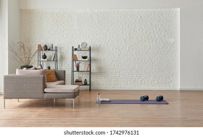 Training at home concept, grey sofa and mat style.