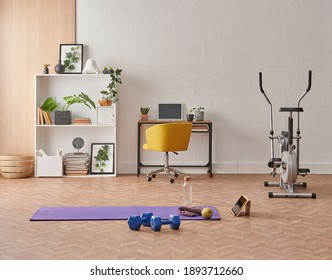 Training at home concept, interior, decorative sport in the room with gym fitness exercise purple mat, dumbbell and bicycle.