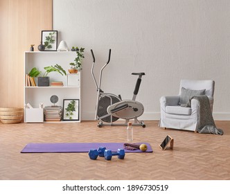 Training At Home Concept, Interior, Decorative Sport In The Room With Gym Fitness Exercise Purple Mat, Dumbbell And Bicycle.