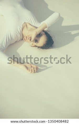 Similar – a girl with her hair by her face lying on the bed