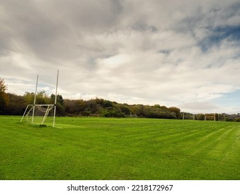 Training Pitch For Irish National Sport Camogie, Hurling, Rugby And Gaelic Football With Tall Goal Posts And Freshly Cut Grass. Nobody. Cloudy Sky. Popular Activity.