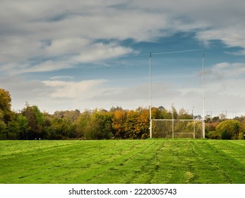 Training pitch for Irish National sport camogie, hurling, rugby and Gaelic football with tall goal posts and freshly cut grass. Nobody. Cloudy sky. Popular activity. - Powered by Shutterstock