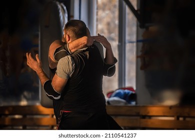 Training And Sparring Of Two Male Muay Thai Athletes In The Gym. Practicing Exercises And Skills During Training In Pairs. The Concept Of An Active, Healthy, Sporty Life