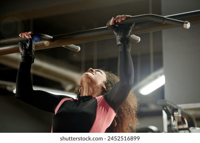 Training, woman and pull up exercise at gym on bar for muscle, wellness or healthy body. Chin up, fitness and strong female person with equipment at club for power, workout and sports for bodybuilder - Powered by Shutterstock