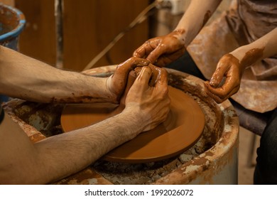 Training for work in the potter's wheel. A man and a woman work together with clay. - Powered by Shutterstock