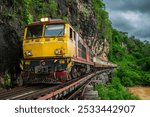 Trains running on death railways track crossing kwai river in kanchanaburi thailand this railways important destination of world war II history builted by soldier prisoners