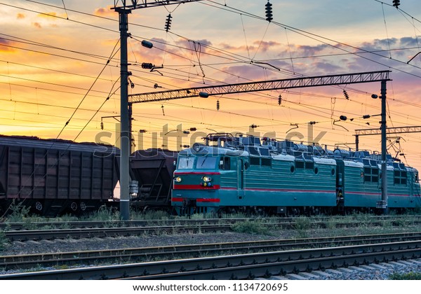 trains and\
wagons, railroad infrastructure, beautiful sunset and colorful sky,\
transportation and industrial\
concept