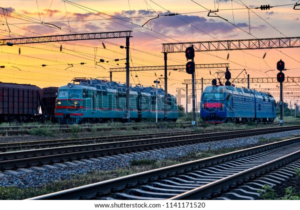 trains and\
wagons, railroad infrastructure, beautiful sunset and colorful sky,\
transportation and industrial\
concept