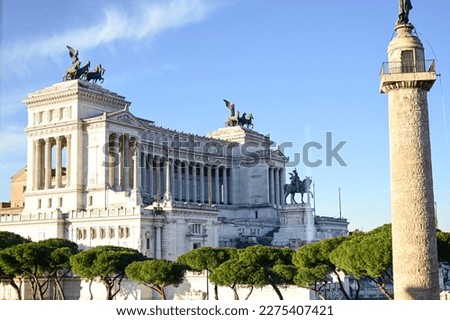  Trajan Column and Facade of the Victorian in Rome, Italy  during the day at sunset.Emmanuel II monument and The Altare della Patria