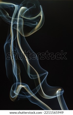 Trajectory of incense smoke in the air showing different shapes. France.