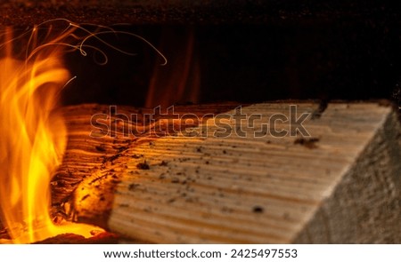 The trajectory of sparks from a burning log in a village stove