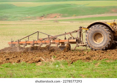Traktok arde la tierra, preparándose para sembrar semillas. Agricultura industrial y agricultura. Conductor de tractores trabajando en el campo. Cosecha, cosecha.