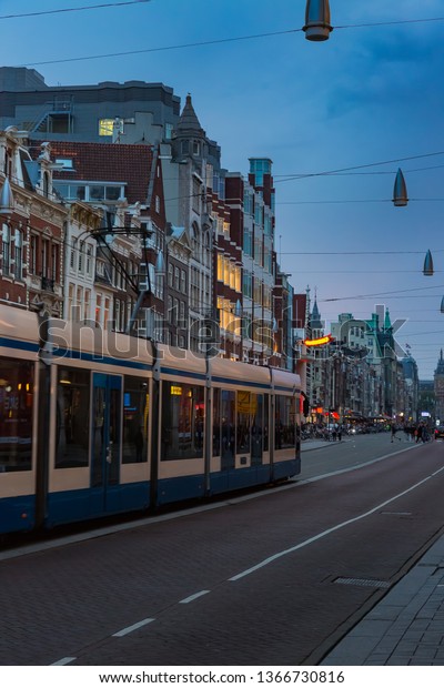 tram in amsterdam at\
night\
