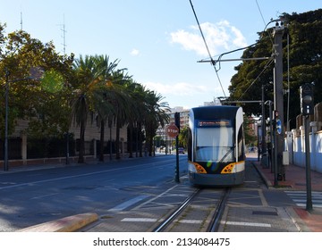 Tram by metrovalencia subway station. Metro train tram at railway station in city Valencia, Spain. Spanish tram, streetcar or trolley. Tramway on rail in city. Tramway in European town.
