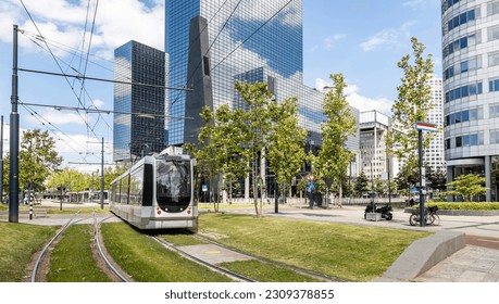 Tram in the city center, public transportation, modern buildings background, sunny day in town