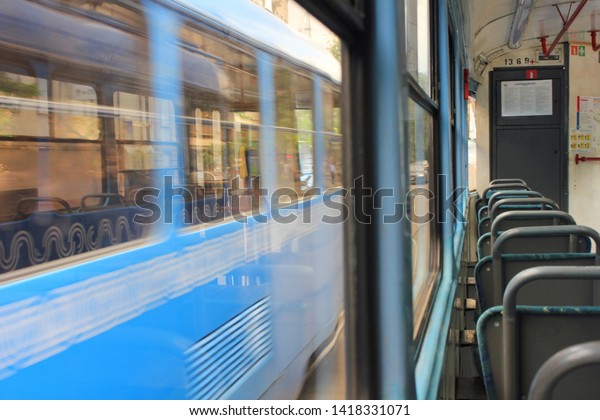 Tram interior with empty seats in\
old fashion public city transport in Moscow on June 2019\
