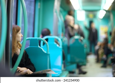 Tram interior, young woman looking aside to other passengers