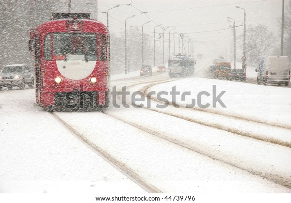 Tram movement\
in city in snowfall in the\
winter.