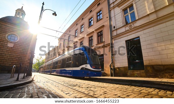 Tram on the street of old town in\
Krakow, Poland. Cityscape with polish public transport\
.