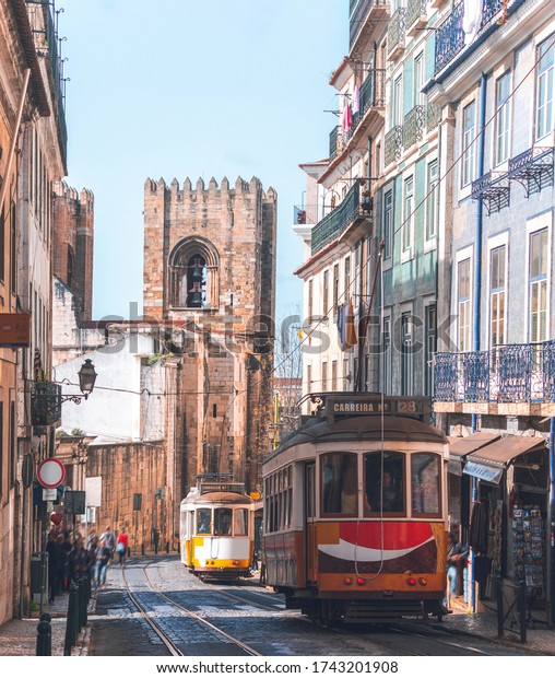 Tram passing the\
Lisbon Cathedral, Portugal