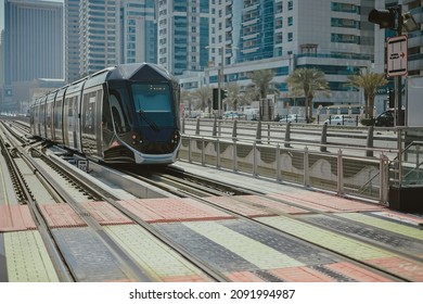Tram public transport moving on railroad line to the platform in Dubai