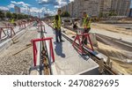 Tram rails at the stage of their installation and integration into concrete plates on the road. Filling by liquid resin for reduction of vibration and noise. process of reconstruction of tram tracks