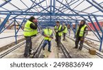 Tram rails at the stage of their integration into concrete plates on the road. Workers make a mix of anti-vibration resin for rail comfort system. The process of reconstruction of tram tracks