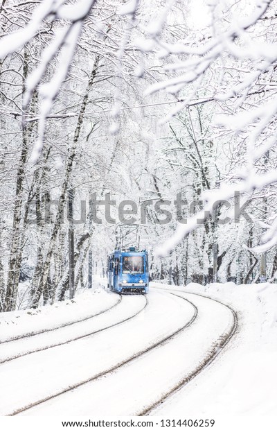 Tram in the snowy city.  Winter urban landscape.\
Winter cityscape with\
tramway