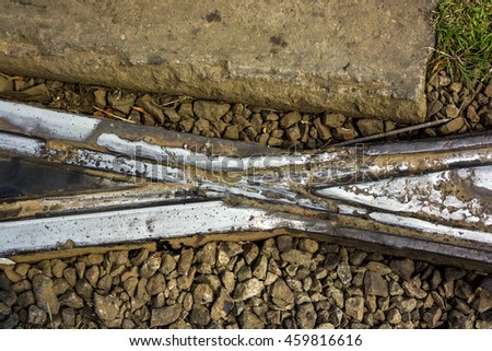 tram track welded crossing pieces against concrete plates and stones