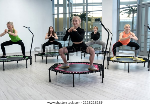 Trampoline for fitness girls are engaged in\
professional sports, the concept of a healthy lifestyle jumping\
trampoline woman fitness gym healthy, for exercise active for\
female for fun movement,\
young