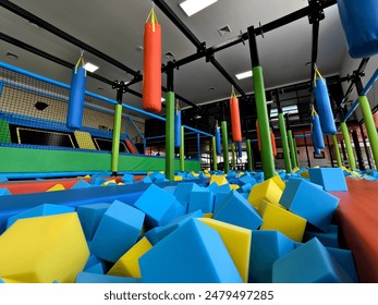 Trampoline park has blue and yellow foam cubes for kids fun