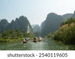 Trang An boat tour. Trang An is known as Ha Long Bay on land. The spectacular landscape is dominated by towering limestone mountains covered with tropical plants, rivers and hidden temples and pagodas