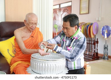 Trang, Thailand - April 13, 2016: Trang Governor Mr.Dejrath Simsiri Pour Water On The Hands Of Lord Abbot Of Buddhist Monastery And Ask For Blessing At Krapang Surin Royal Temple.