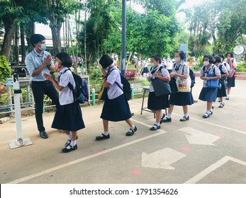 Trang, Thailand - August 6, 2020 : Young Female Students From Banyantakhao School Wear Surgical Face Mask To Protect Covid-19 Pay Respect To Male Teacher Before Leaving School And Return To Home