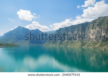 Tranquil Blue Lake Nestled Amidst Majestic Mountains Under a Clear Blue Sky