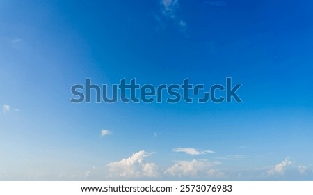 Tranquil Blue Sky with Wispy Clouds Over Calm Horizon  