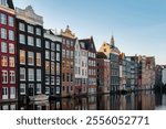 The tranquil canals of Amsterdam shine under autumn