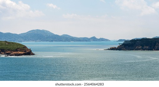 Tranquil Coastal Landscape with Distant Islands and Clear Blue Sky   - Powered by Shutterstock