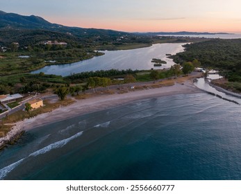 Tranquil coastal sunset with lagoon, beach, and gentle waves. - Powered by Shutterstock