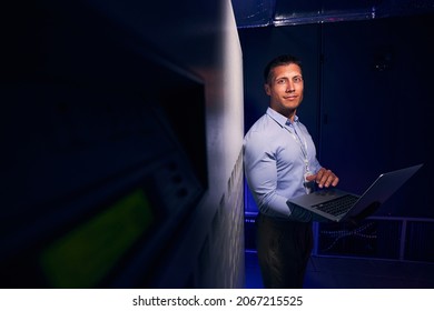 Tranquil IT Engineer With Laptop In Server Room