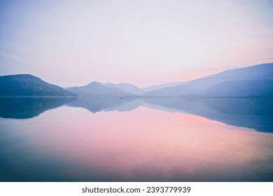 
Tranquil Horizon: Minimalistic Panorama of Clouds, Mountains, and Lake
 - Powered by Shutterstock