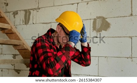 Tranquil housebuilder preparing for construction work in unfinished new building